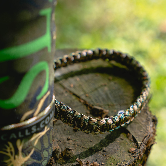 Close up of the Swagger elk bugle tube in Kryptek Altitude camo cover, with paracord strap by Slayer Calls