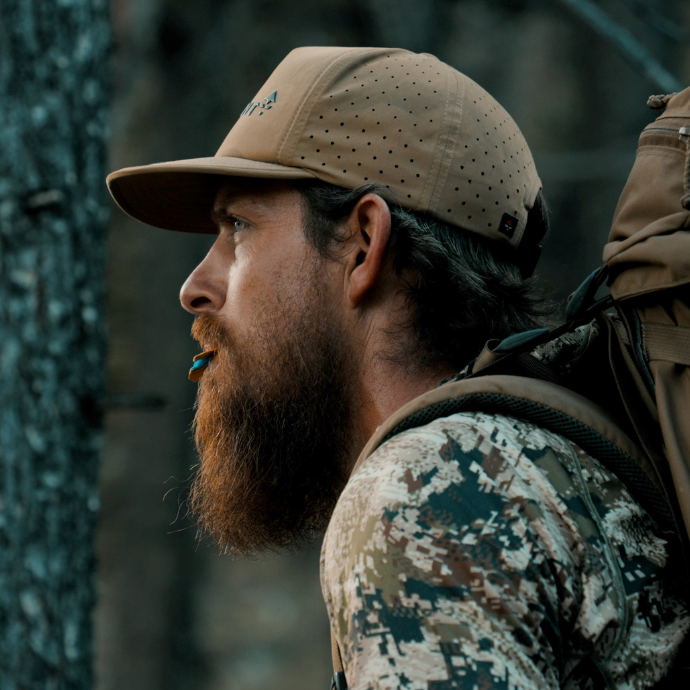 Close-up of elk hunter using navy blue Lochsa Elk Reed from the Clearwater Diaphragm Series in the elk woods.