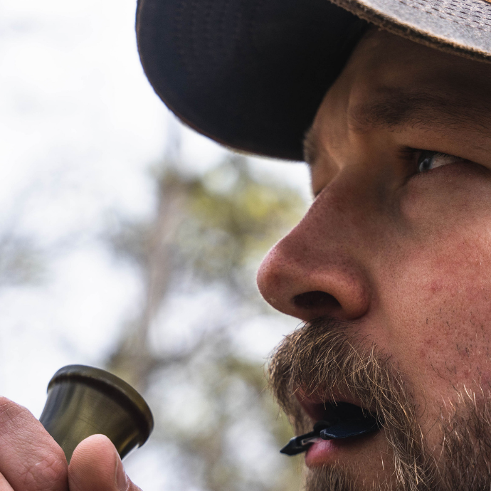 Close up image of elk hunter using Logger Elk Reed from the Clearwater Diaphragm Series and ArchAngel bugle tube