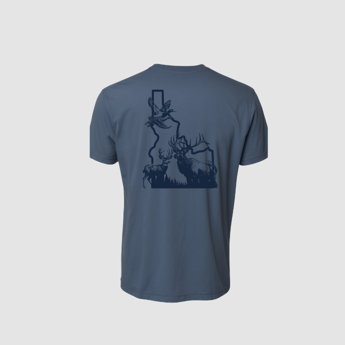 Back view of Slayer hunting T-shirt featuring elk, deer, and ducks in flight graphic overlay on Idaho state map on slate blue fabric.