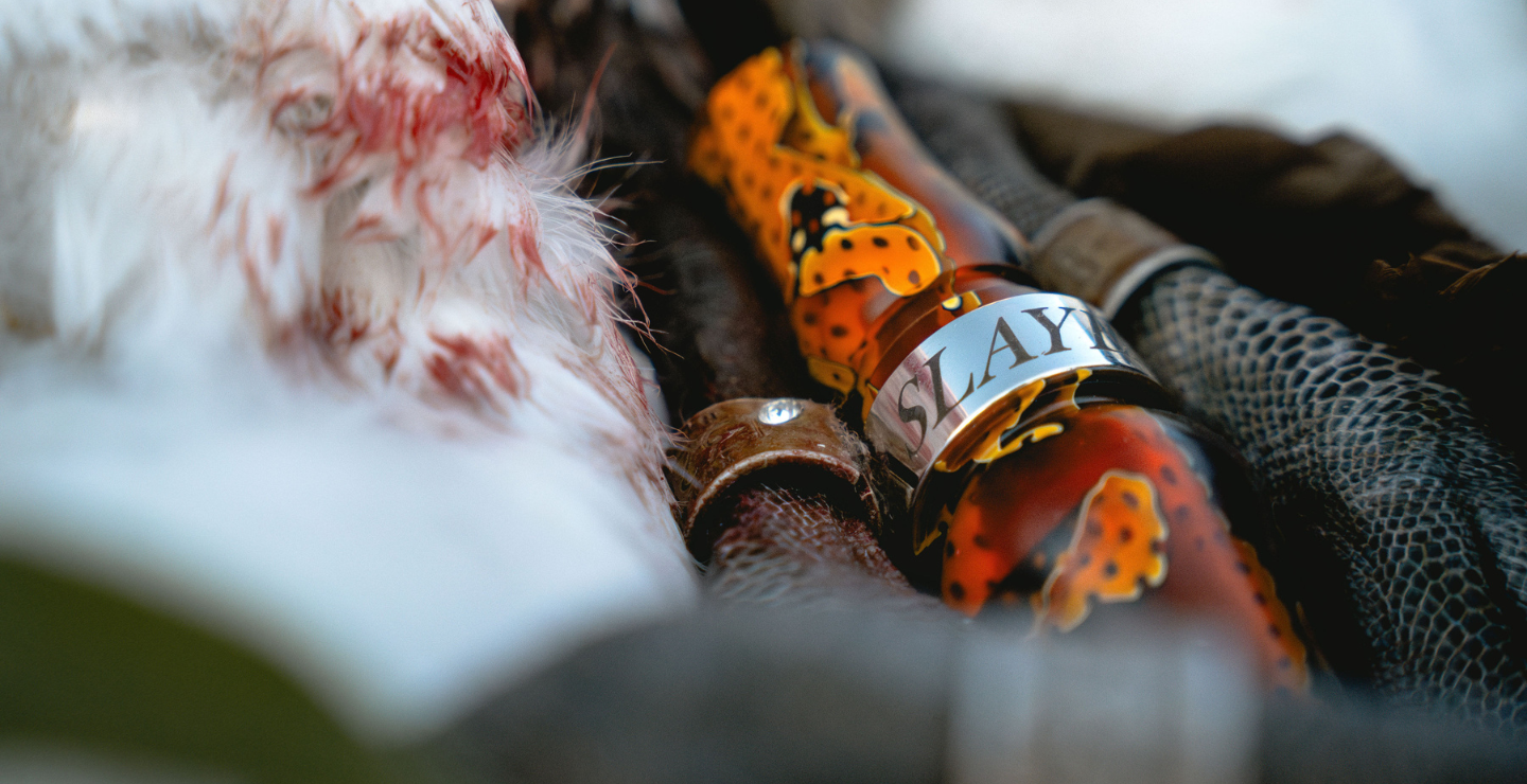 Slayer's honker slayer goose call in citrine orange featured next to harvested banded goose.