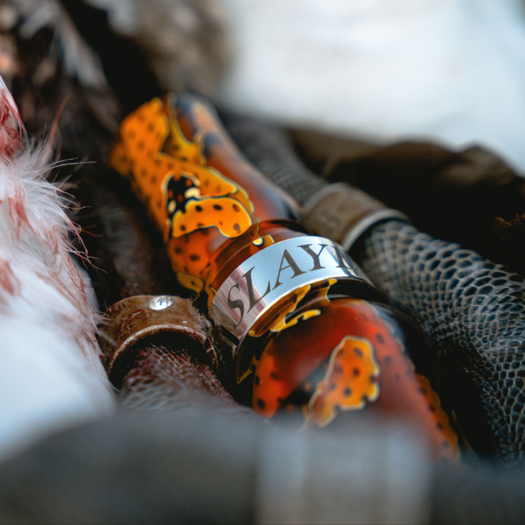 Slayer's honker slayer goose call in citrine orange featured next to harvested banded goose.