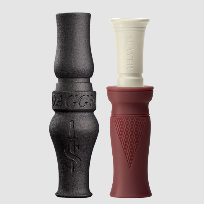 Two waterfowl calls, one black goose call and one washed red duck call, on a light gray background.