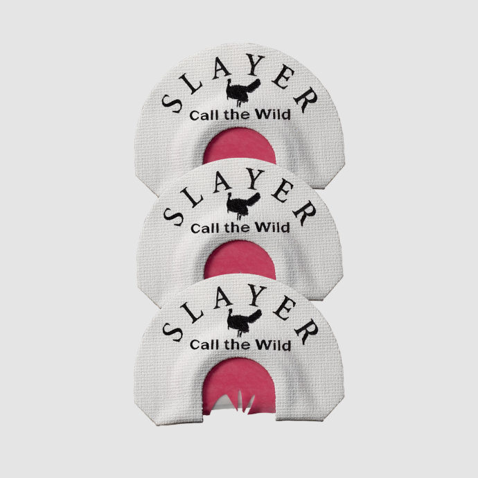 Three white and red turkey mouth calls with Slayer - Call the Wild printed on them on a light grey background
