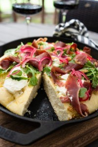 Smoked duck fat focaccia topped with duck prosciutto - close up