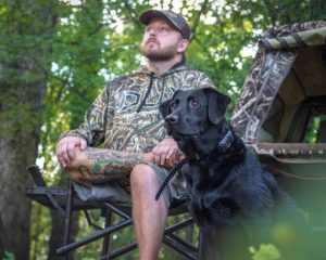 Duck hunter, Hayden Martin with his black lab Hurley