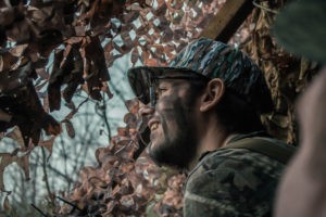 Duck hunter in the blind, smiling