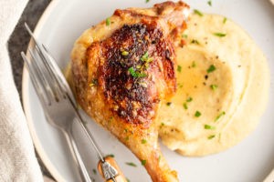 Braised duck legs with parsnip puree on a plate