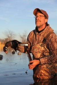 Duck hunter gear resources: duck hunter wearing waders in water