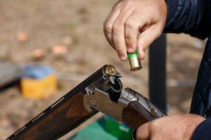 Hunting shotguns on haystack, soft focus on shutgun butt