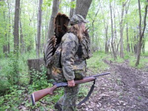 Turkey hunter stands in trees