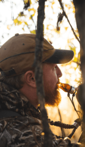 Hunter using the Ranger Single Reed duck call in Citrine Water Mesh by Slayer