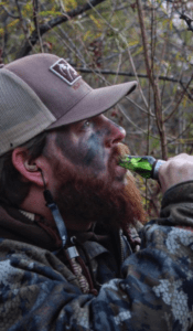 Hunter with Slayer's Ranger Single Reed duck call in green marsh