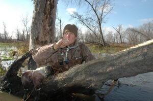 Hunter in the water with goose call —Geese hunting strategies