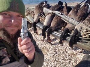 Waterfowl hunter Mike Wec pictured holding Slayer's Honker goose call in snow mesh